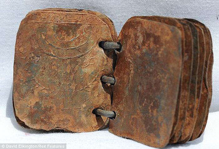 Click the image for a view of: One of the metal tablets, Photo: David Elkington/Rex Features